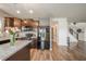 Modern kitchen boasts dark wood cabinets, sleek black appliances, and an island with light countertops at 6579 Aster Dr, Pendleton, IN 46064