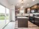 Kitchen area with dark brown cabinets, stainless steel appliances, and a sliding glass door at 6579 Aster Dr, Pendleton, IN 46064