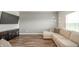Living room with sectional sofa, modern lighting, and laminate wood flooring at 6579 Aster Dr, Pendleton, IN 46064