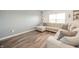 Comfortable living room with a plush sectional sofa, modern lighting, and laminate wood flooring at 6579 Aster Dr, Pendleton, IN 46064