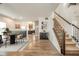 Open-concept living room and staircase with hardwood floors and neutral decor at 6579 Aster Dr, Pendleton, IN 46064