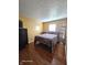 Bedroom with hardwood floors, classic decor, and ample natural light, creating a warm and inviting space at 6723 Silver Tree Dr, Indianapolis, IN 46236
