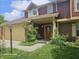 Two-story townhouse with an attached garage, covered entry, and mature landscaping at 6723 Silver Tree Dr, Indianapolis, IN 46236