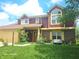 Well-maintained townhouse featuring mature landscaping, a two-car garage, and a welcoming front entrance at 6723 Silver Tree Dr, Indianapolis, IN 46236