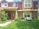 Inviting two-story townhouse featuring a brick and red siding exterior, complemented by a well-maintained front lawn at 6723 Silver Tree Dr, Indianapolis, IN 46236