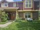 Charming townhouse featuring a covered porch, brick accents, and well-manicured front yard at 6723 Silver Tree Dr, Indianapolis, IN 46236