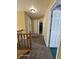 Hallway with carpet, yellow walls, and multiple doors, including one to the left and one straight ahead at 6723 Silver Tree Dr, Indianapolis, IN 46236