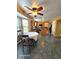 Eat-in kitchen featuring tile floors, a ceiling fan, an island, modern appliances, and an attached breakfast nook at 6723 Silver Tree Dr, Indianapolis, IN 46236
