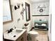 Well-lit bathroom featuring a floral wallpaper, decorative mirror, and tiled floors at 675 W Morgan St, Martinsville, IN 46151