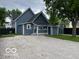 Charming blue home with well-maintained lawn and gravel driveway at 675 W Morgan St, Martinsville, IN 46151