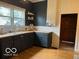 Well-appointed kitchen with black cabinetry, wood countertop, and shelving at 675 W Morgan St, Martinsville, IN 46151