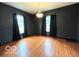 Spacious living room with hardwood floors, large windows, and ample natural light at 675 W Morgan St, Martinsville, IN 46151