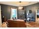 Cozy living room with dark accent walls, fireplace and hardwood floors at 675 W Morgan St, Martinsville, IN 46151