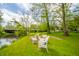 Serene backyard setting featuring outdoor chairs and a creek under a bridge at 6762 S State Road 67, Pendleton, IN 46064