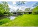 Picturesque backyard scene with a gentle stream flowing under a sturdy bridge at 6762 S State Road 67, Pendleton, IN 46064
