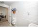 Bathroom detail showcasing a floral wall hanging and linen storage at 6762 S State Road 67, Pendleton, IN 46064