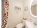 Well-lit bathroom featuring floral shower curtain, shelving, and neutral fixtures at 6762 S State Road 67, Pendleton, IN 46064