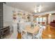 Bright eat-in kitchen with an eating area, wood-burning stove, and stylish white cabinets and shelves at 6762 S State Road 67, Pendleton, IN 46064