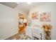 Bright hallway with view to the living room, desk, and beautiful floral arrangements at 6762 S State Road 67, Pendleton, IN 46064