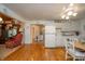 Bright kitchen featuring white appliances, a dining area, and an open design into the living space at 6762 S State Road 67, Pendleton, IN 46064