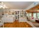A bright kitchen features light-colored cabinets, hardwood floors, and an adjoining living area at 6762 S State Road 67, Pendleton, IN 46064