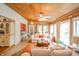 Open-concept living room with a wood ceiling, abundant natural light, and comfortable seating for relaxing at 6762 S State Road 67, Pendleton, IN 46064