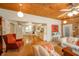 Cozy living room with wood ceiling, a glimpse into the dining area, and comfortable seating arrangement at 6762 S State Road 67, Pendleton, IN 46064