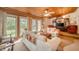 Bright living room with wood ceiling, large windows, and comfortable seating with a ceiling fan at 6762 S State Road 67, Pendleton, IN 46064