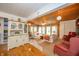 Spacious living room with hardwood floors, wood ceiling, and a cozy seating area with a ceiling fan at 6762 S State Road 67, Pendleton, IN 46064