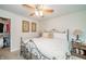 Comfortable main bedroom showcasing a decorative bed frame, ceiling fan, and ensuite closet at 6762 S State Road 67, Pendleton, IN 46064