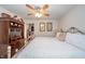 Comfortable main bedroom features a ceiling fan, closet, and decorative armoire at 6762 S State Road 67, Pendleton, IN 46064