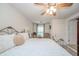 Main bedroom with ceiling fan, sitting area, access to an ensuite bathroom and walk-in closet at 6762 S State Road 67, Pendleton, IN 46064