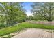 Expansive backyard featuring a wooden deck, green lawn, and mature trees at 6833 Bluffridge Ln, Indianapolis, IN 46278