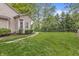 Spacious backyard with green grass, trees, and a stone pathway at 6833 Bluffridge Ln, Indianapolis, IN 46278