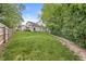 Large backyard with green lawn, mature trees, and a wooden fence at 6833 Bluffridge Ln, Indianapolis, IN 46278