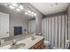Bathroom with double sinks, a large mirror, and a shower-tub combination at 6833 Bluffridge Ln, Indianapolis, IN 46278