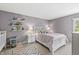 Cozy bedroom with a comfortable bed, shelving, and natural light at 6833 Bluffridge Ln, Indianapolis, IN 46278