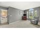 Cozy bedroom with a comfy armchair and a large window that allows natural light to stream inside at 6833 Bluffridge Ln, Indianapolis, IN 46278