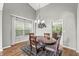 Cozy dining room featuring hardwood floors, a chandelier, and a large window with backyard views at 6833 Bluffridge Ln, Indianapolis, IN 46278