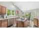 Updated kitchen with stainless steel appliances, an island cooktop, and a breakfast nook with lots of natural light at 6833 Bluffridge Ln, Indianapolis, IN 46278