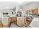 Spacious kitchen with wood cabinets, stainless appliances, and an island cooktop for cooking and entertaining at 6833 Bluffridge Ln, Indianapolis, IN 46278
