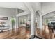 Spacious living room featuring hardwood floors, a vaulted ceiling, and large windows for natural light at 6833 Bluffridge Ln, Indianapolis, IN 46278