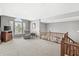 Spacious living room featuring large windows and an open staircase at 6833 Bluffridge Ln, Indianapolis, IN 46278