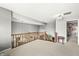 Open loft area with a wooden railing, carpet flooring, and views of the living room below at 6833 Bluffridge Ln, Indianapolis, IN 46278