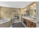 Luxurious main bathroom with marble countertops, dual sinks, and a soaking tub at 6833 Bluffridge Ln, Indianapolis, IN 46278
