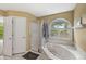 Elegant main bathroom with a marble-clad bathtub and separate glass-enclosed shower at 6833 Bluffridge Ln, Indianapolis, IN 46278