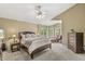 Spacious main bedroom suite with plush carpet, a ceiling fan, and access to a private outdoor area at 6833 Bluffridge Ln, Indianapolis, IN 46278