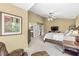 Well-lit main bedroom with a ceiling fan, plush carpet, and access to a bathroom at 6833 Bluffridge Ln, Indianapolis, IN 46278