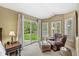Inviting sitting area with comfortable armchair, ottoman, and a view of the backyard at 6833 Bluffridge Ln, Indianapolis, IN 46278