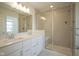 Modern bathroom with double sinks, white cabinetry, granite counters, and glass enclosed shower at 6871 Adalene Ln, Carmel, IN 46033